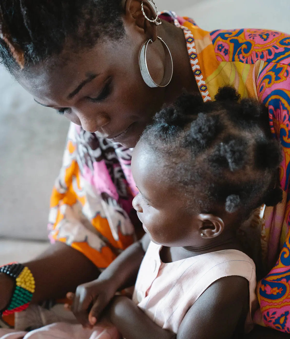 Mother and young child cuddling photo by Greta Hoffman with Pexels