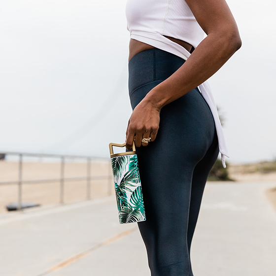 Athletic mom carrying Mila's Keeper Insulated Breast Milk Cooler