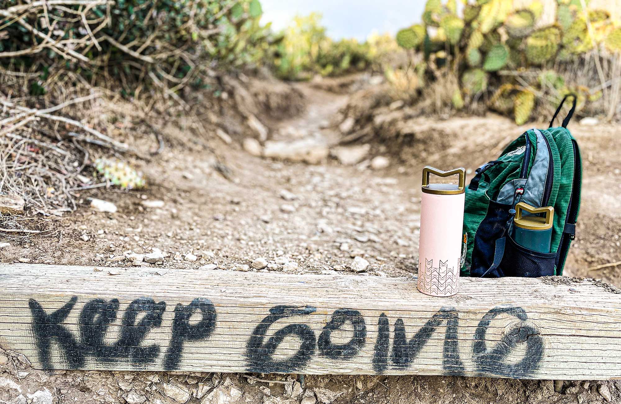 Keep Going Message with Mila's Keeper Insulated Cooler on hiking trail - coastline California