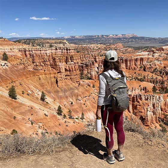 Founder of Mila's Keeper overlooking Bryce Canyon National Park using insulated breast milk cooler as water bottle