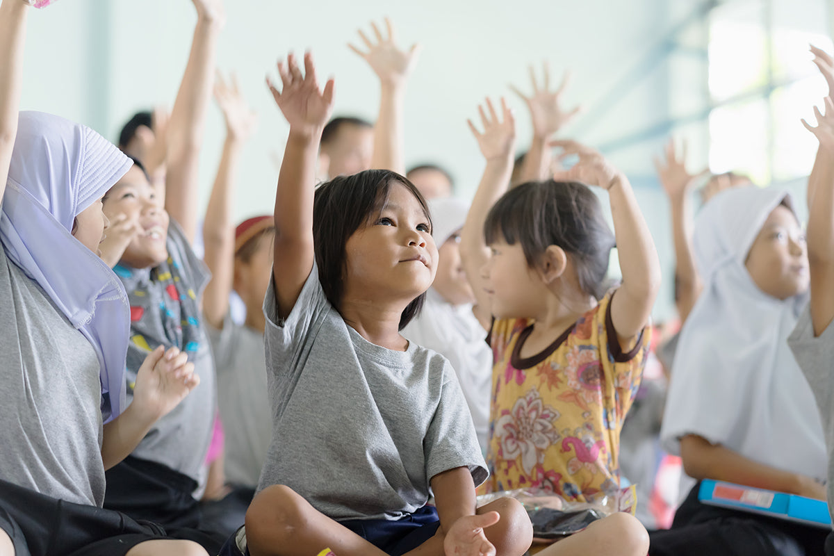 Image of school girls raising their hand