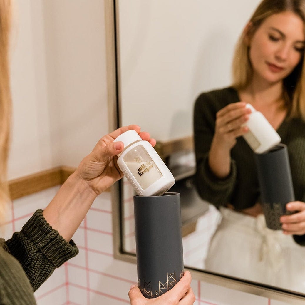 Working Mom putting breast milk storage into Mila's Keeper Insulated Cooler in public bathroom.